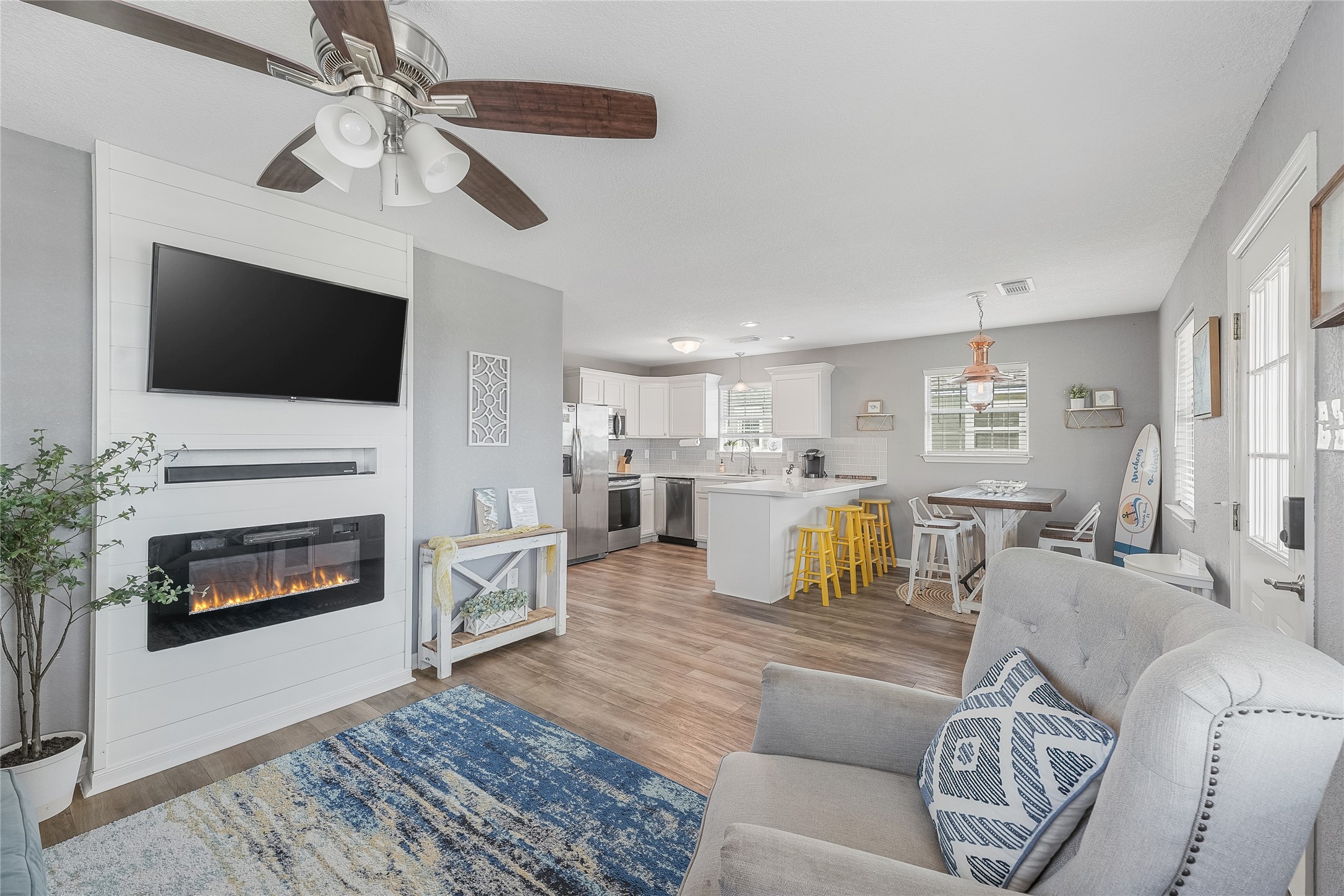 a living room with furniture a fireplace and a flat screen tv