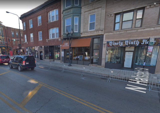 a couple of cars parked in front of brick building