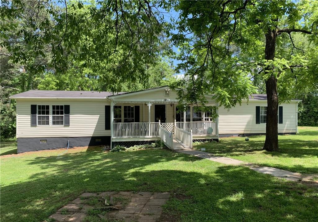 6675 Millwood Road Gainesville, GA 30506 - Photo 1 of 13 a view of a house with a yard and a tree