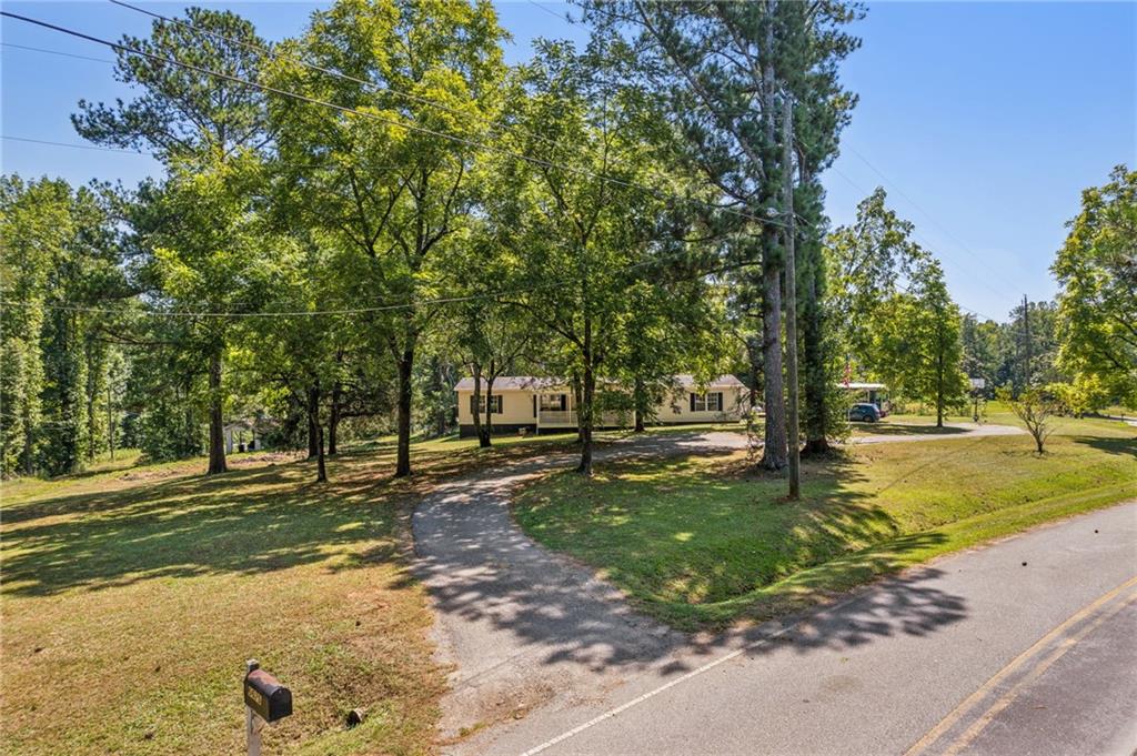 6675 Millwood Road Gainesville, GA 30506 - Photo 2 of 13 a view of a tree in a yard