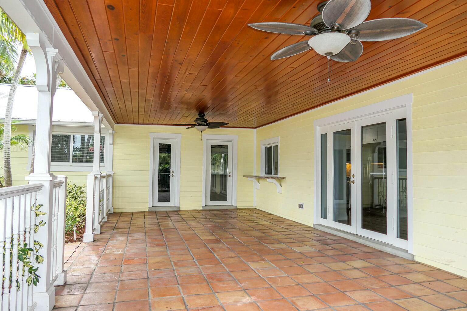 18014 Perigon Way Jupiter, FL 33458 - Photo 23 of 35 a view of a hall with wooden floor and a ceiling fan