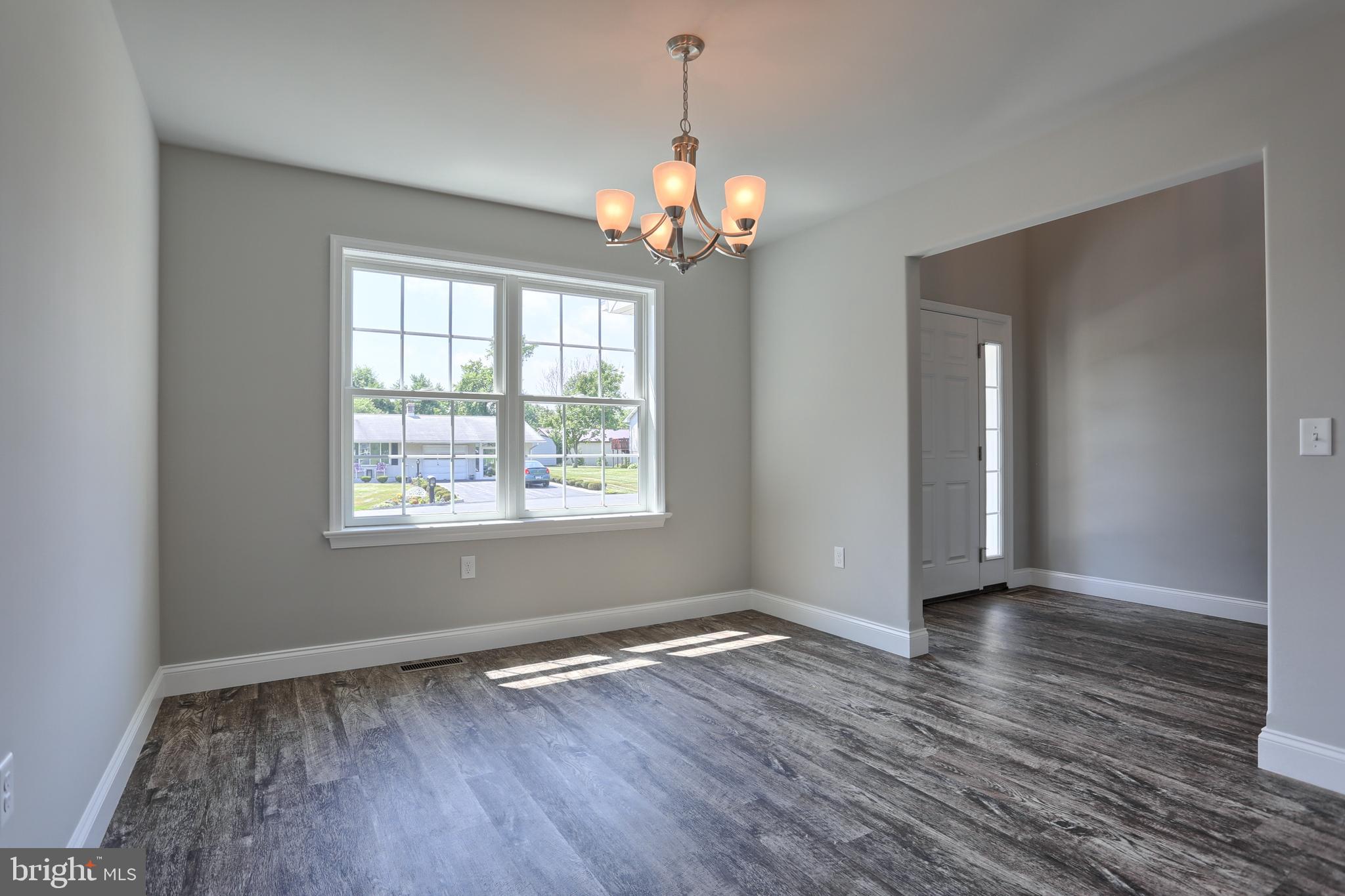 10 Rolling Meadow Road Lebanon, PA 17046 - Photo 4 of 29 a view of an empty room with wooden floor and a window