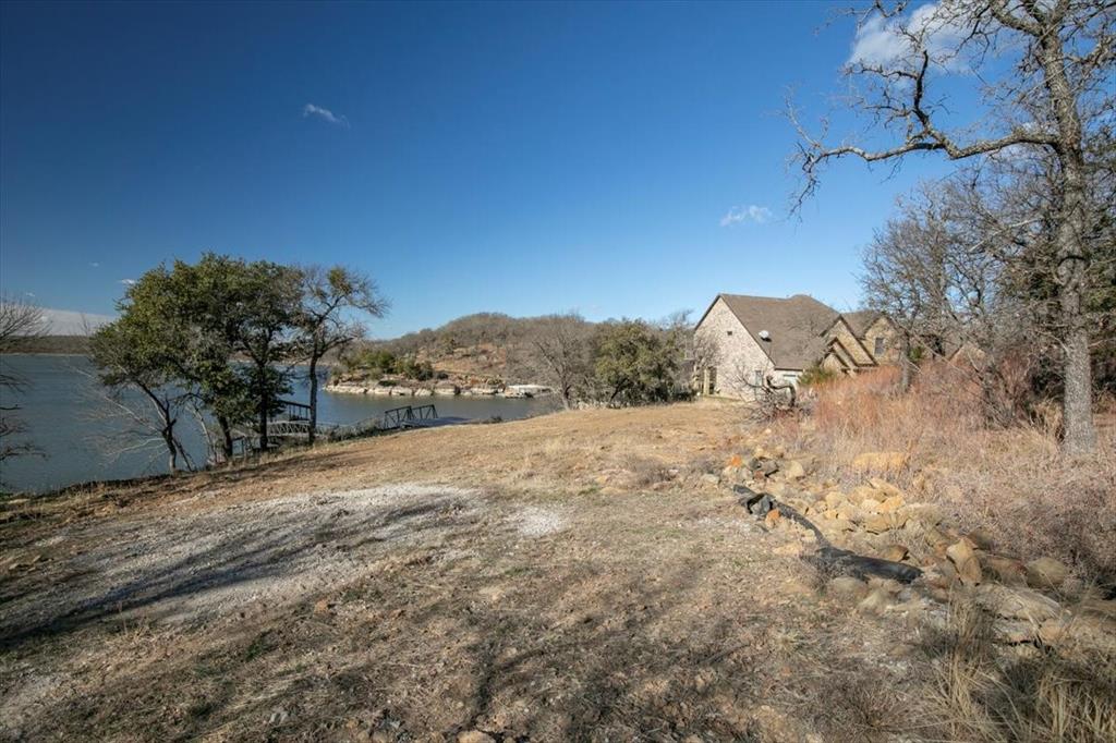 167 Cote D Azur Chico, TX 76431 - Photo 20 of 35 a view of a dry yard with trees