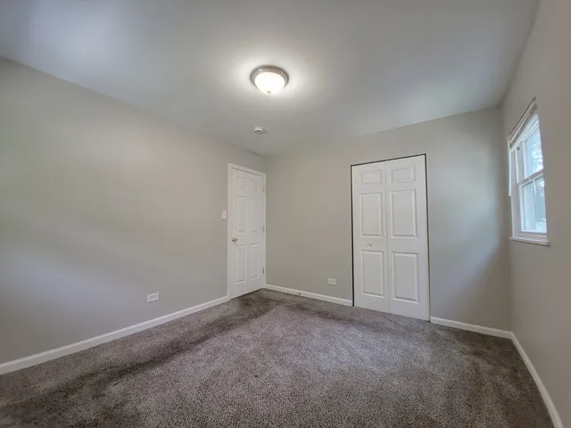 an empty room with a empty space and windows