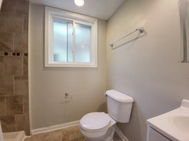 a white toilet sitting next to a bathroom sink