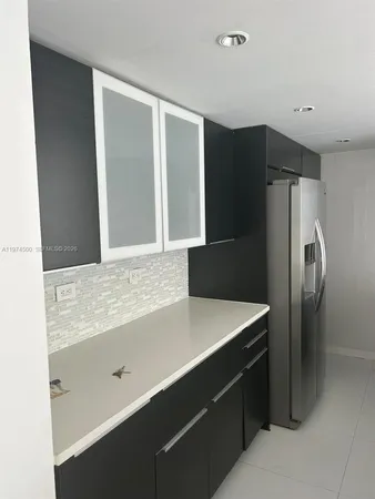 a kitchen with a refrigerator and a sink