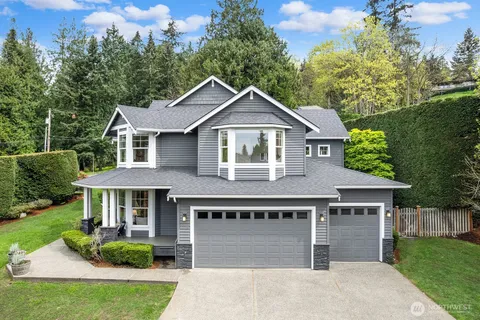 a front view of a house with yard and green space