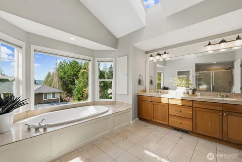 a bathroom with a granite countertop sink and a large mirror