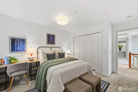 a bedroom with a bed and a chair
