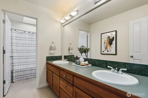 a bathroom with a double vanity sink and a mirror