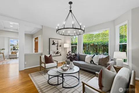 a living room with furniture a table and a large window