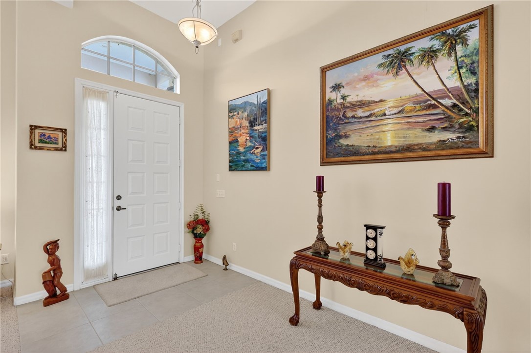 3075 73rd Place Vero Beach, FL 32967 - Photo 1 of 30 a living room with furniture and a wall painting