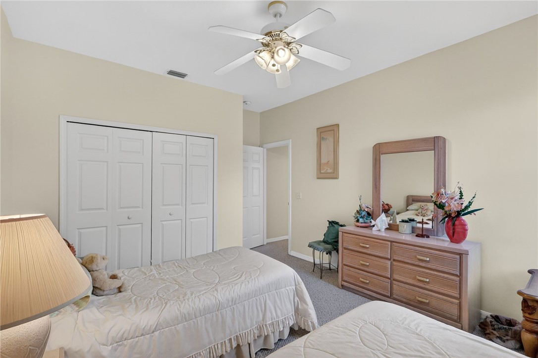 3075 73rd Place Vero Beach, FL 32967 - Photo 15 of 30 a bedroom with a bed and a dresser