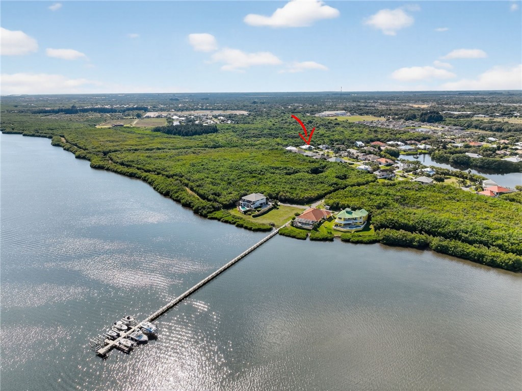 3075 73rd Place Vero Beach, FL 32967 - Photo 18 of 30 an aerial view of a house with a garden and lake view