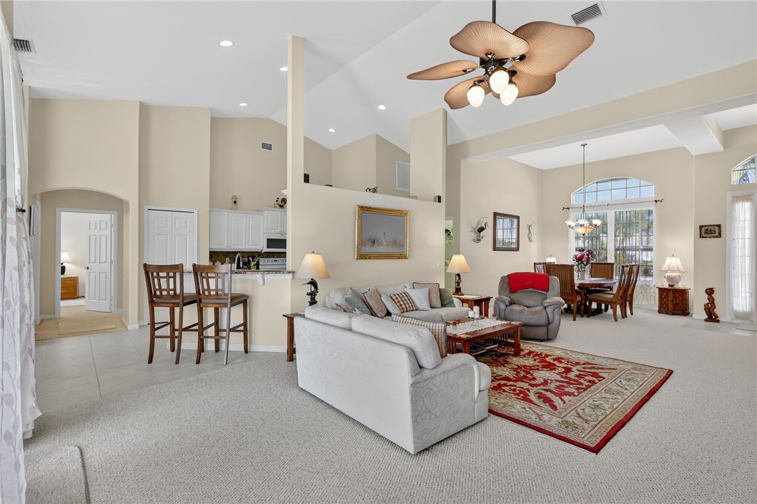 3075 73rd Place Vero Beach, FL 32967 - Photo 3 of 30 a living room with furniture kitchen view and a chandelier