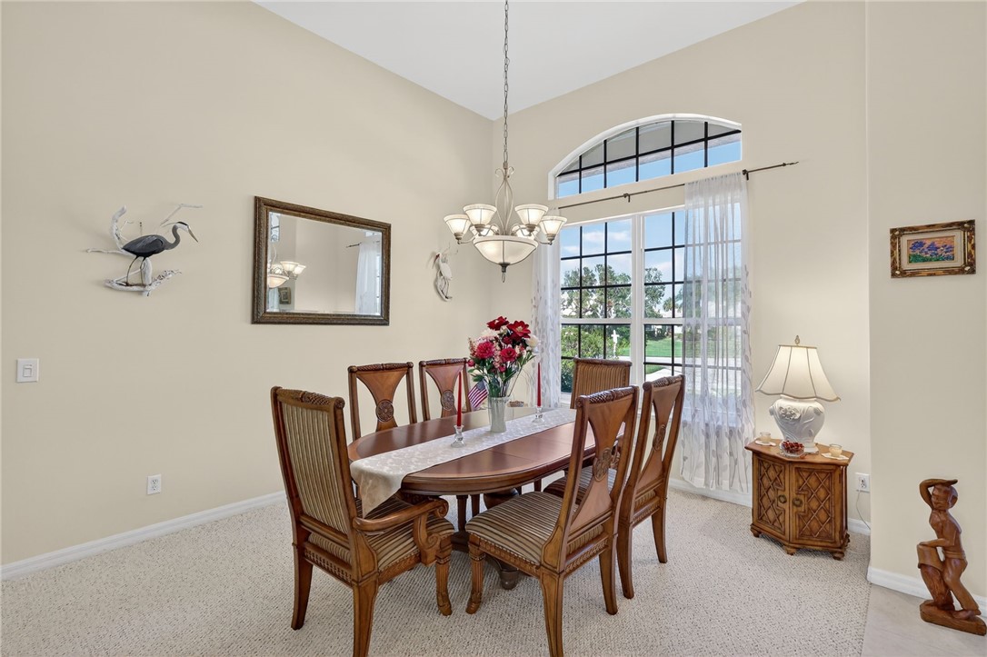 3075 73rd Place Vero Beach, FL 32967 - Photo 4 of 30 a dining room with furniture and chandelier