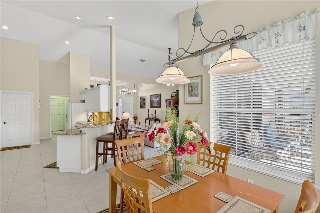 3075 73rd Place Vero Beach, FL 32967 - Photo 7 of 30 a outdoor dining space with furniture and white walls