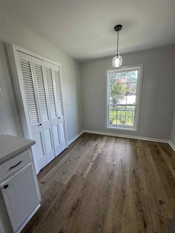 6349 Ivanhoe Lane Beaumont, TX 77706 - Photo 3 of 10 a view of an empty room with wooden floor and a window