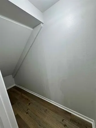 a view of walk in closet with empty racks