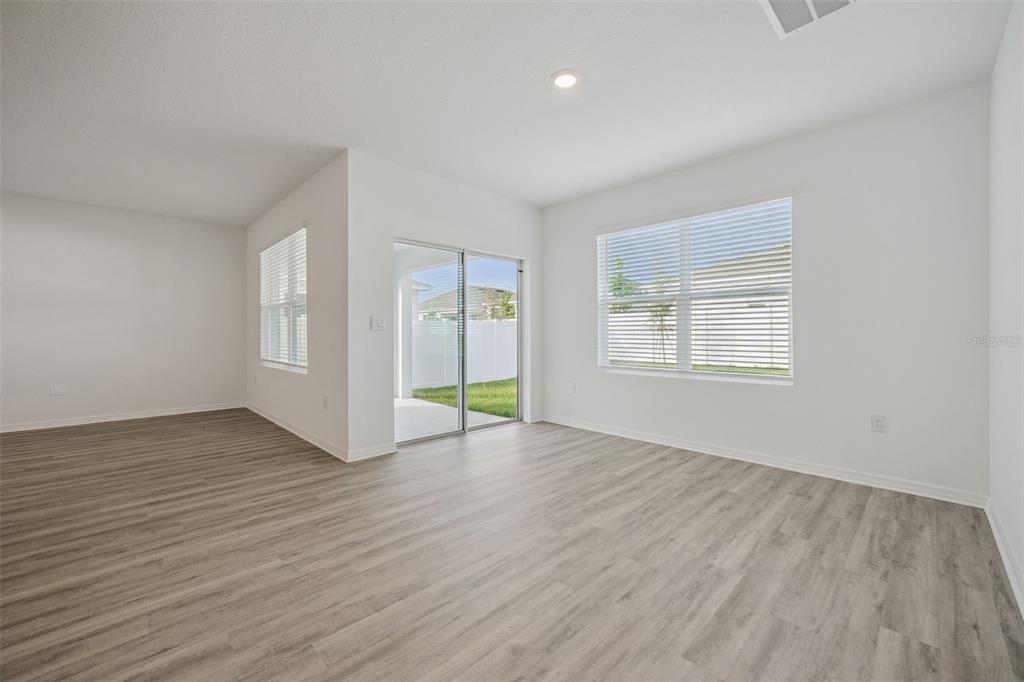 3515 Nettle Loop Tavares, FL 32778 - Photo 14 of 58 an empty room with wooden floor and windows