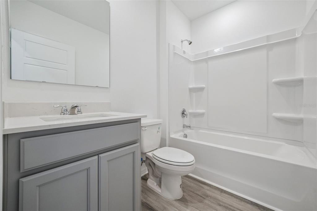 3515 Nettle Loop Tavares, FL 32778 - Photo 23 of 58 a bathroom with a sink toilet and shower