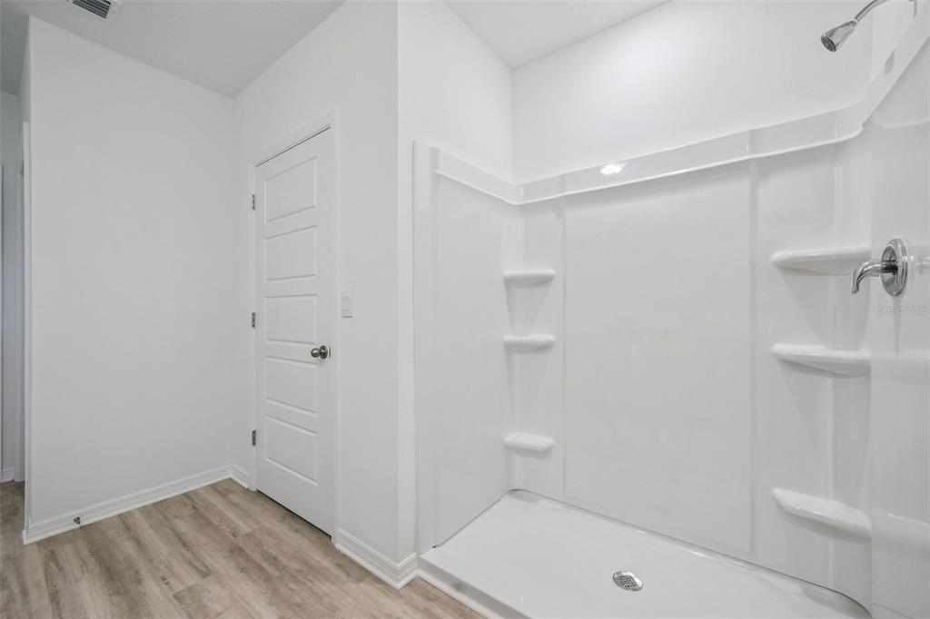 3515 Nettle Loop Tavares, FL 32778 - Photo 25 of 58 a bathroom with a tub and shower