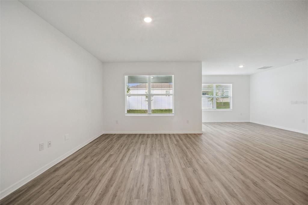 3515 Nettle Loop Tavares, FL 32778 - Photo 5 of 58 an empty room with wooden floor and windows