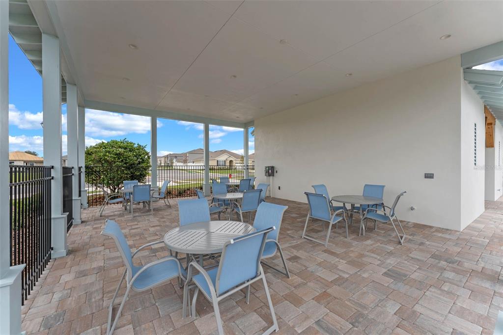 3515 Nettle Loop Tavares, FL 32778 - Photo 51 of 58 a dining room with furniture and a floor to ceiling window