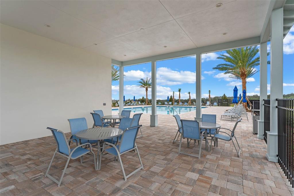 3515 Nettle Loop Tavares, FL 32778 - Photo 52 of 58 a dining room with furniture and a floor to ceiling window