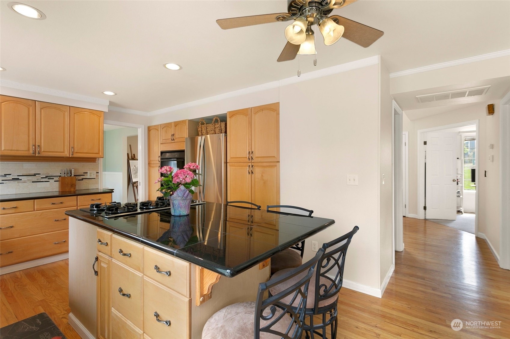 1915 235th Street Southeast Bothell, WA 98021 - Photo 12 of 33 a kitchen with stainless steel appliances granite countertop a sink a stove and island with wooden floor