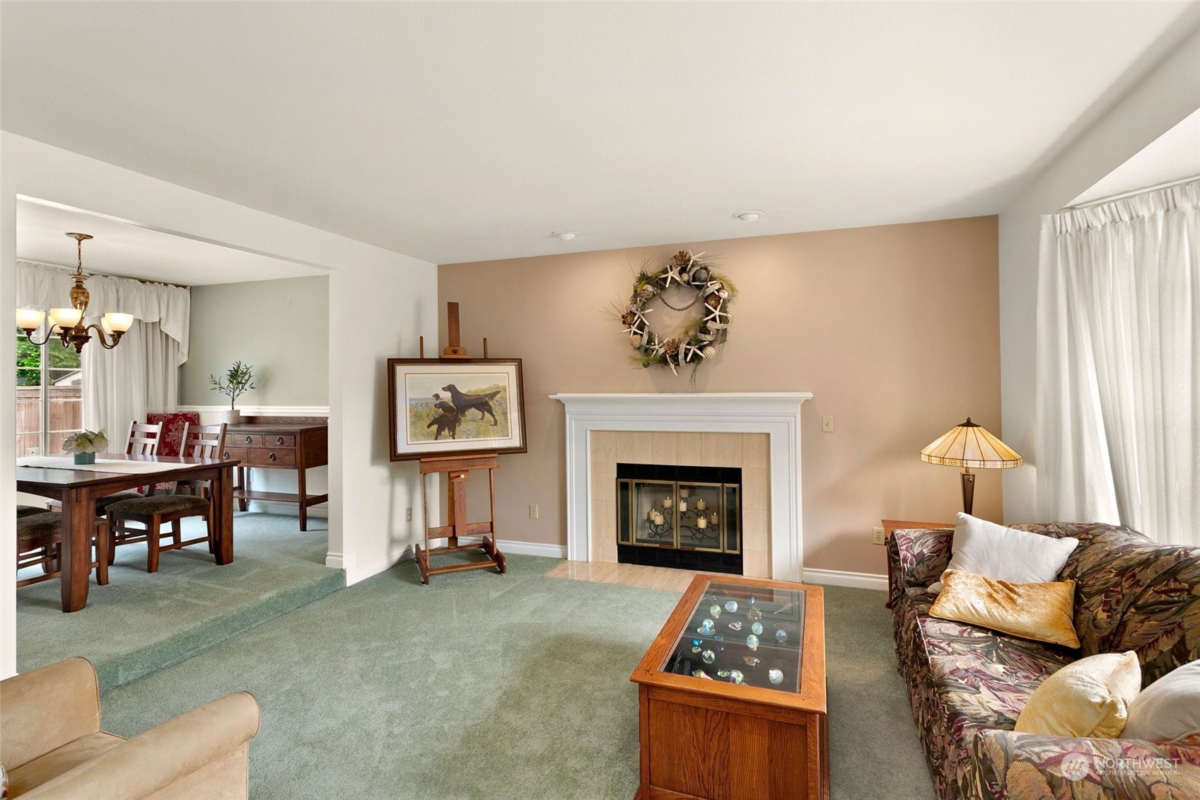 1915 235th Street Southeast Bothell, WA 98021 - Photo 6 of 33 a living room with furniture a fireplace and paintings on the wall