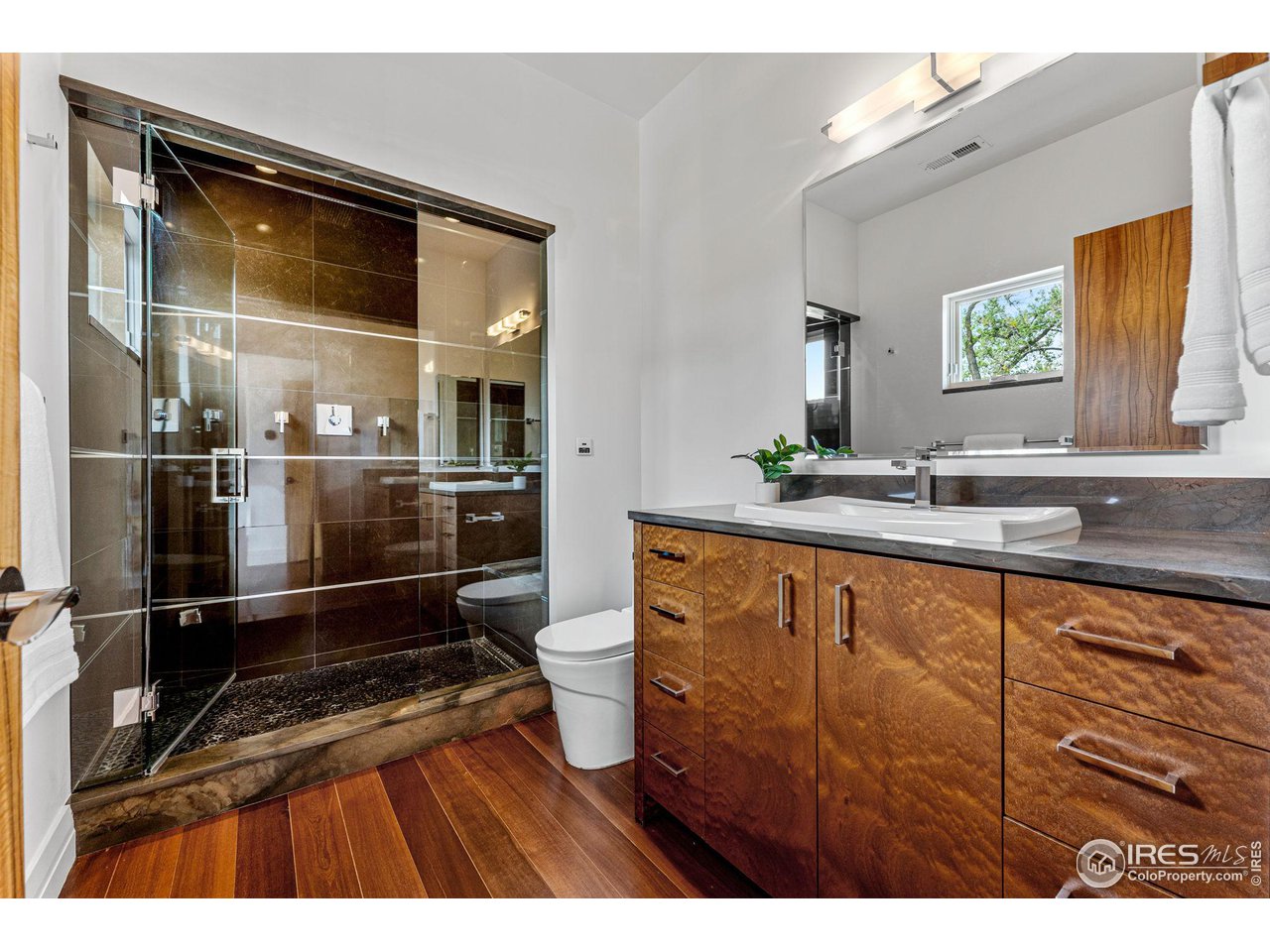 1000 Spring Drive Boulder, CO 80303 - Photo 29 of 40 a bathroom with a sink a mirror and a toilet