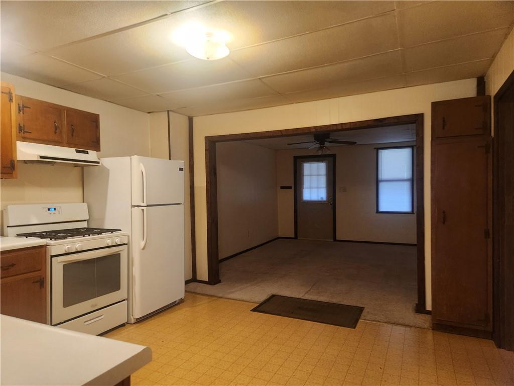 859 Old State Road Apollo, PA 15613 - Photo 4 of 10 a kitchen with a refrigerator and a stove