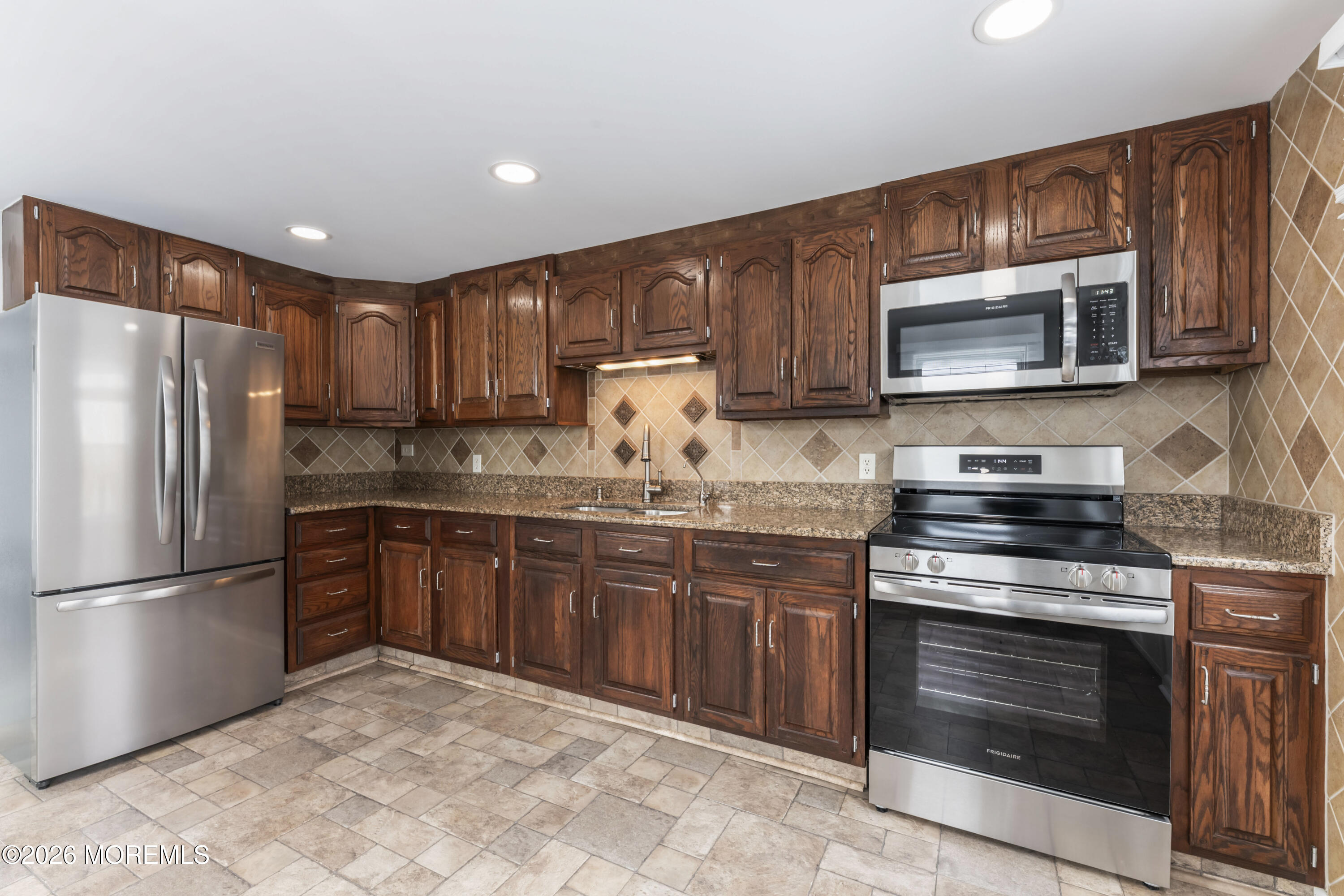83 Chesterfield Jacobstown Road Wrightstown, NJ 08562 - Photo 12 of 52 a kitchen with granite countertop wooden cabinets stainless steel appliances and a sink