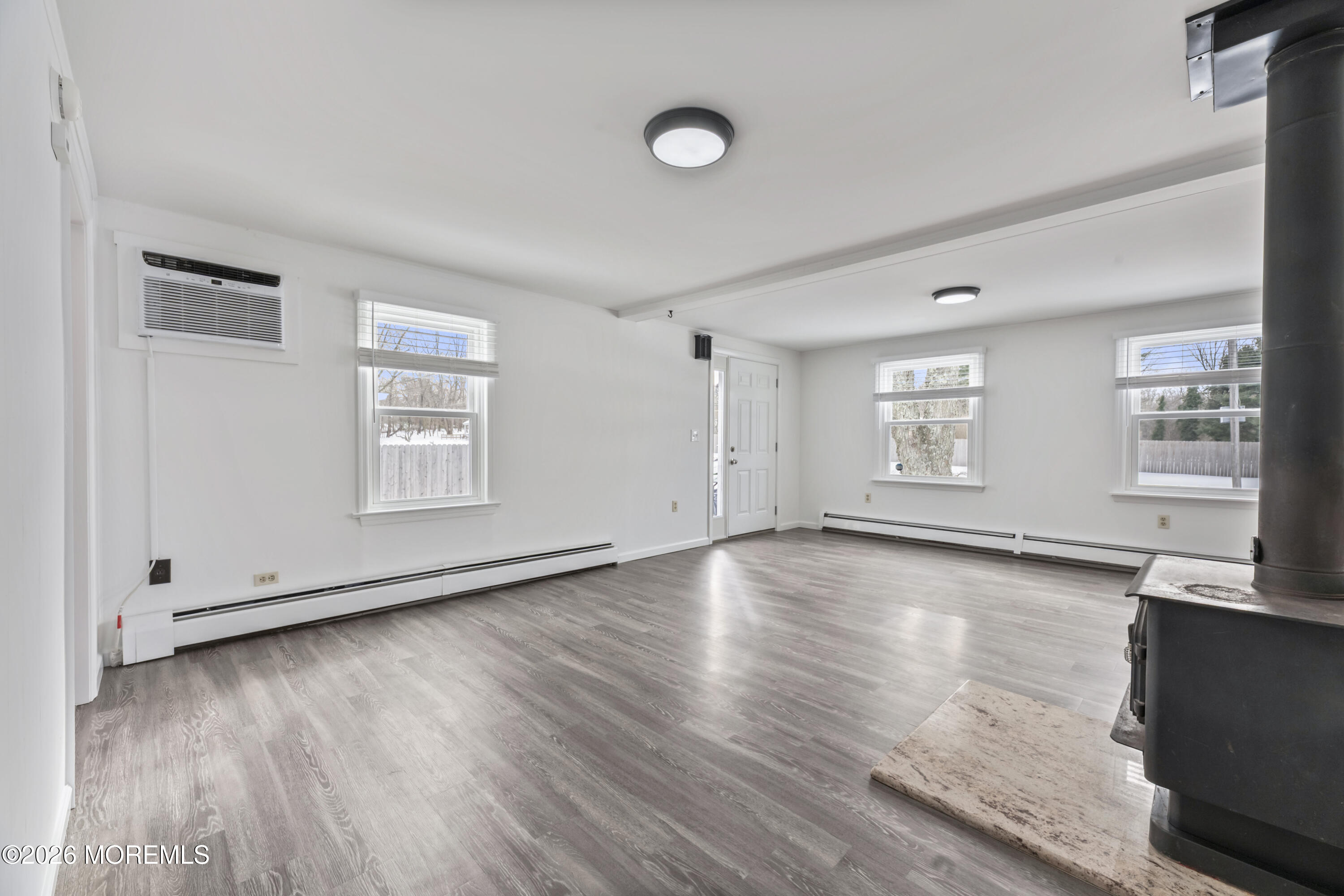 83 Chesterfield Jacobstown Road Wrightstown, NJ 08562 - Photo 8 of 52 an empty room with wooden floor and windows