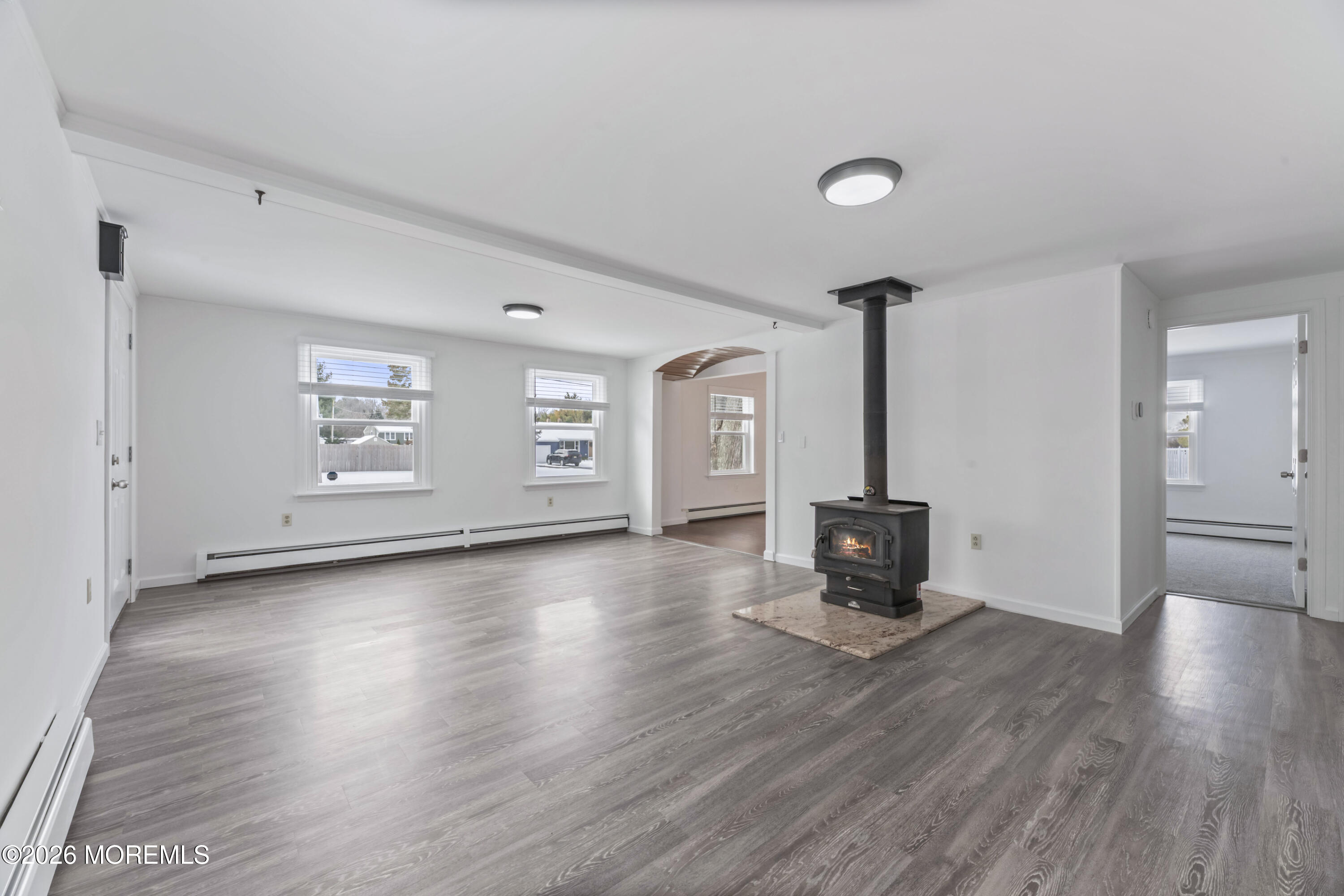 83 Chesterfield Jacobstown Road Wrightstown, NJ 08562 - Photo 9 of 52 an empty room with wooden floor and windows
