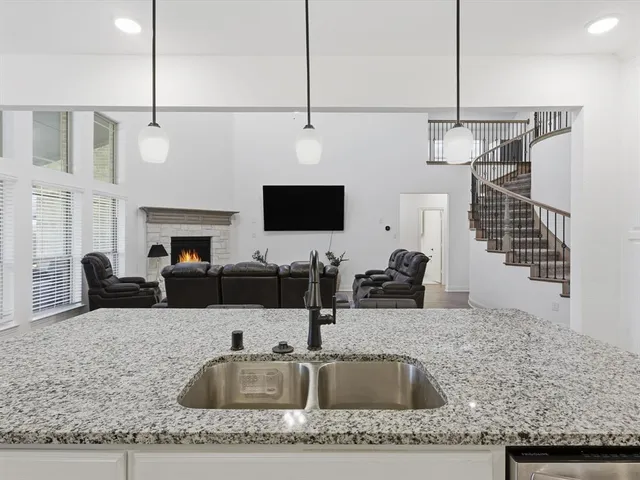 a kitchen with a sink a counter space and cabinets