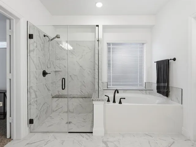 a bathroom with a bathtub and a shower