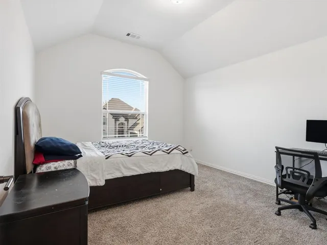 a bedroom with a bed and a chair