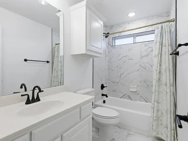 a bathroom with a sink a toilet and a bathtub