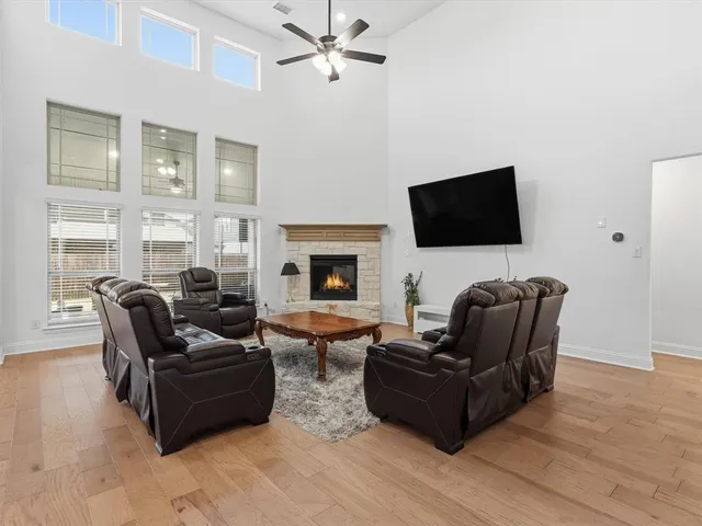 a living room with furniture a flat screen tv and a fireplace