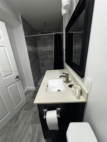 a bathroom with a sink a toilet and mirror
