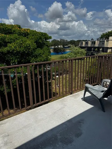a view of a roof deck with wooden fence and floor