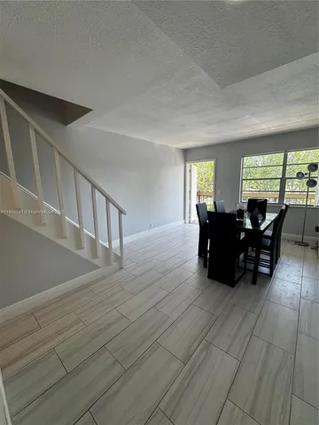 a living room with furniture window and wooden floor