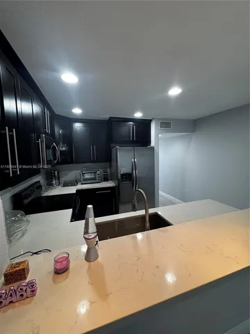 a kitchen with counter top space and stainless steel appliances
