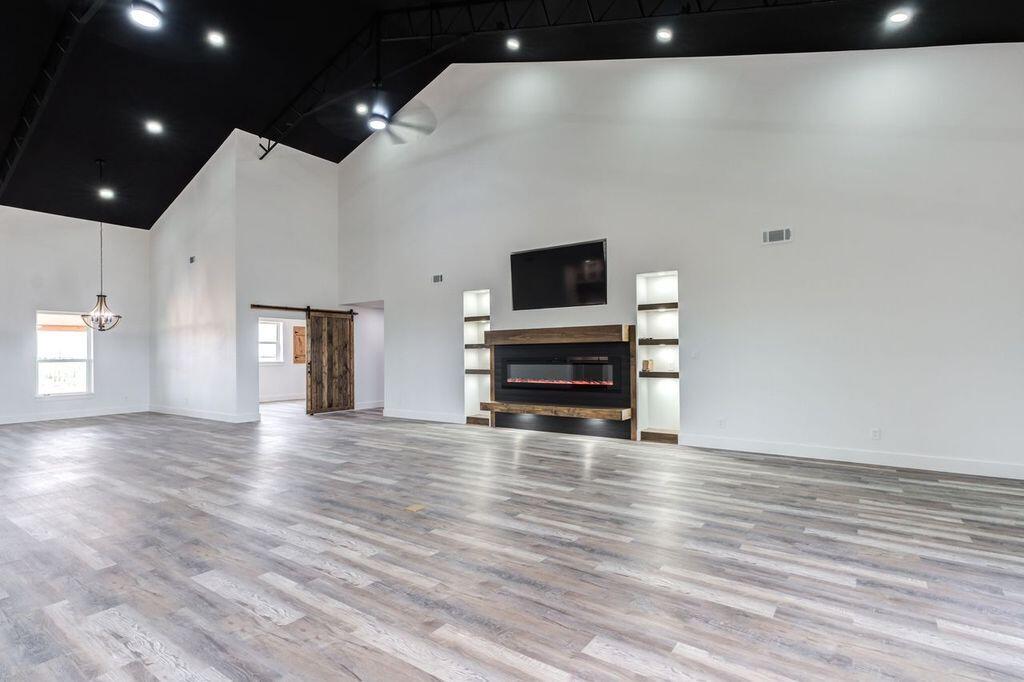 6601 North C R 1500 Shallowater, TX 79363 - Photo 12 of 39 a view of empty room with wooden floor and cabinet