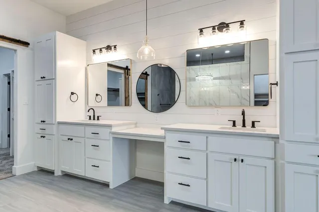 a spacious bathroom with double sink and a mirror