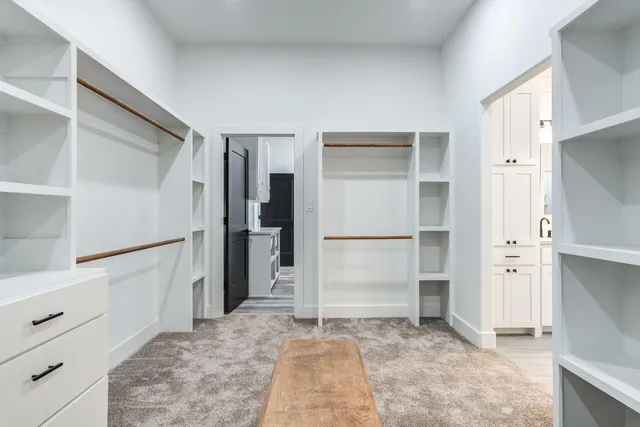 a view of walk in closet with empty racks