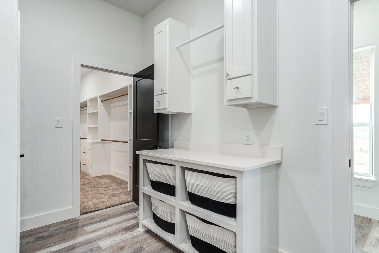 6601 North C R 1500 Shallowater, TX 79363 - Photo 23 of 39 a kitchen with white cabinets and appliances