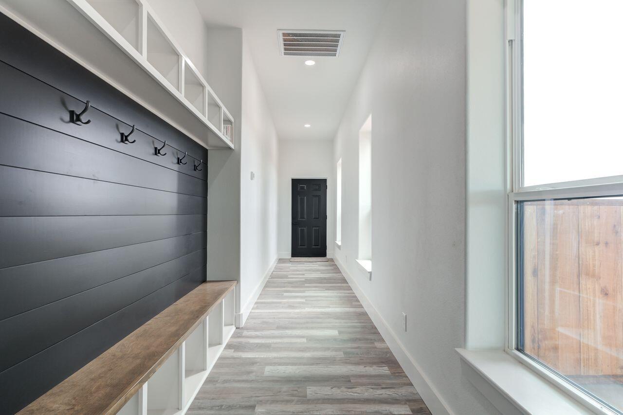 6601 North C R 1500 Shallowater, TX 79363 - Photo 25 of 39 a view of a hallway with wooden floor and staircase